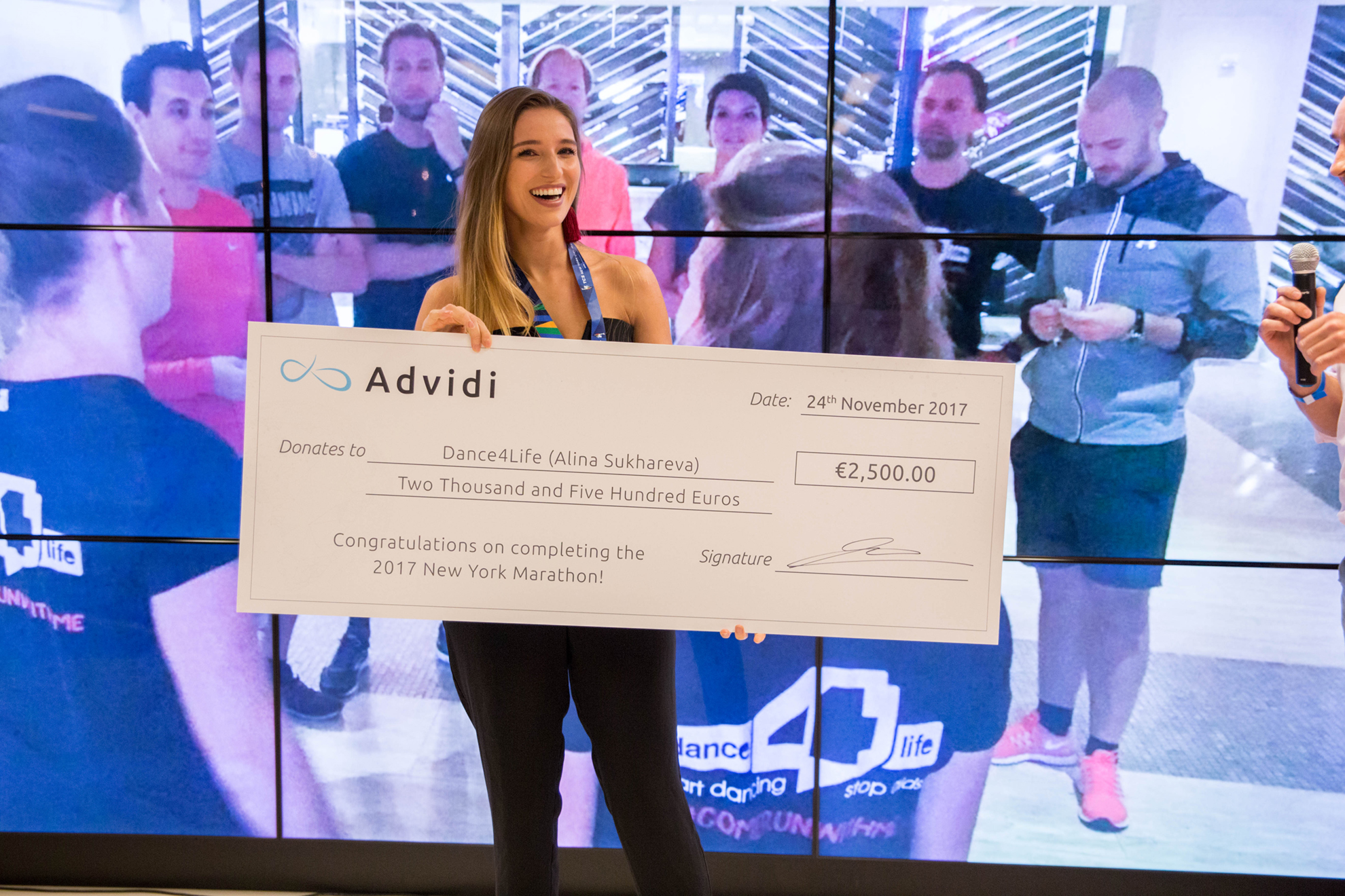 Alina collects the donation from Advidi